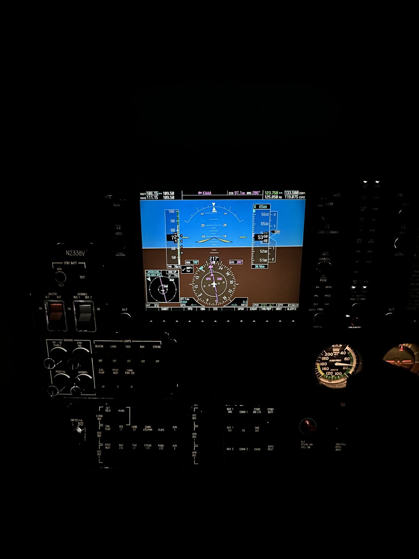 Glass cockpit panel lit up during a night flight